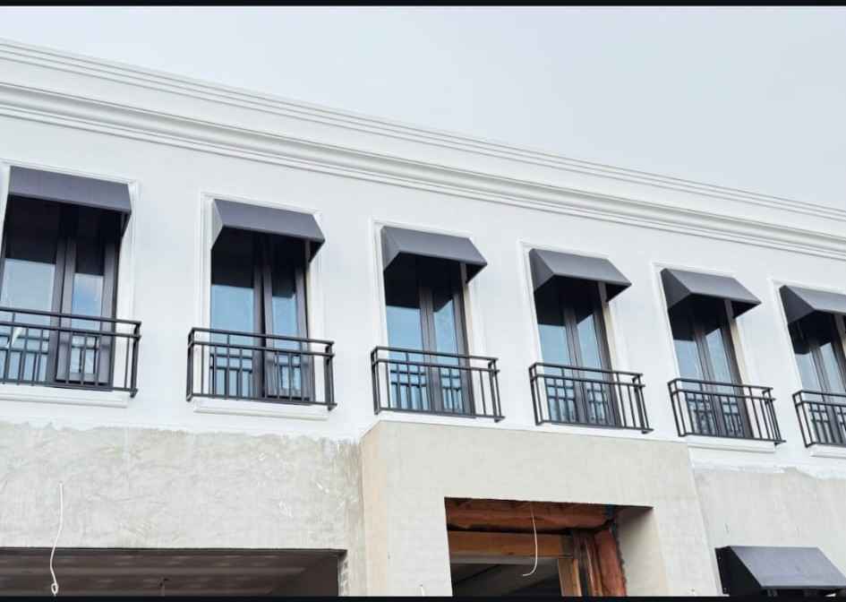Wrought iron Juliet balconies on a white facade